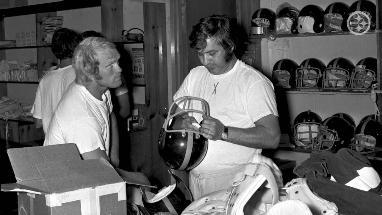 Tony Parisi works with Terry Bradshaw on his facemask for his helmet.