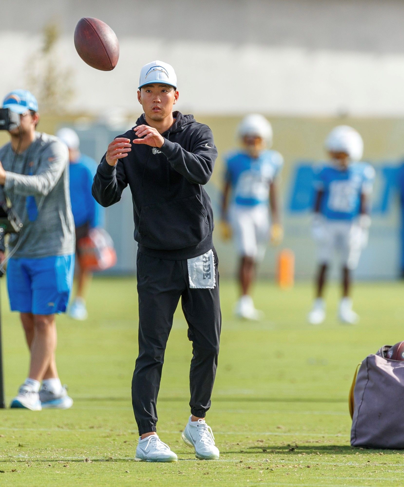 Tristan Greene, Seasonal Intern with the Chargers, works on the field during practice.