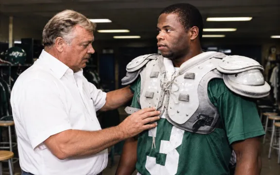 Bill Hampton Fits 1987 Draft Pick Onzy Elam for Shoulder Pads