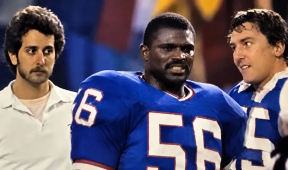 Jay Brunetti during his Washington days, sharing a moment on the field with division rival Lawrence Taylor of the New York Giants. In the NFC East, even equipment guys could find themselves in close quarters with the opposition. (Photo courtesy of Jay Brunetti)