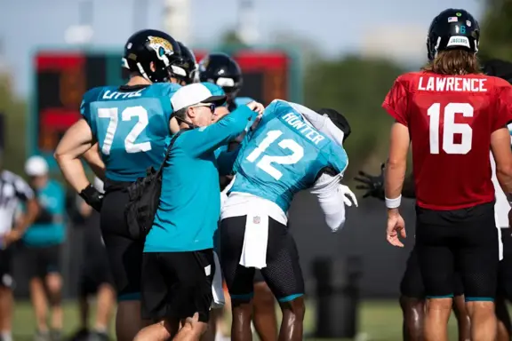 Jags Equipment Manager assists Travis Hunter