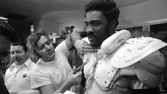 Tony Parisi working on shoulder pads