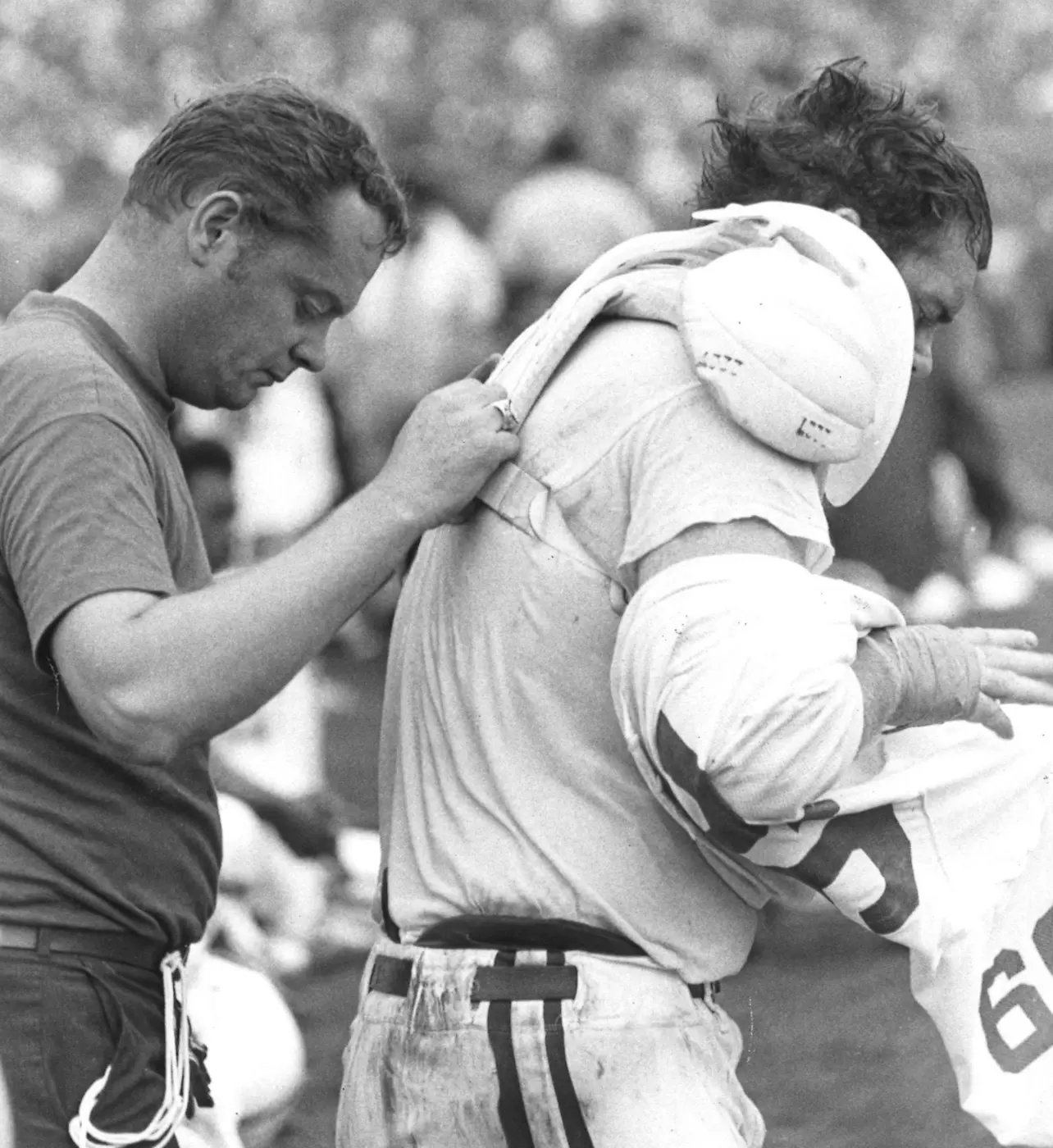 Bill Hampton Helping With Shoulder Pads